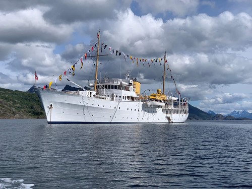 Royal Norwegian vessel sailing in a norwegian fjord