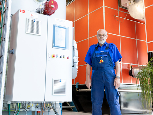 District heating manager in front of a Parat electric boiler