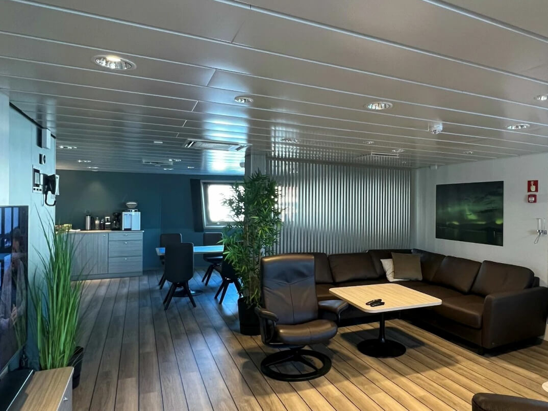 TV lounge with coffee bar in the background on the Norwegian well boat Ronja Aurora built by Aas Mek Verksted for the shipping company Sølvtrans