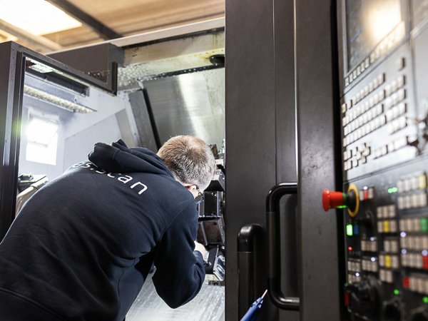 CNC specialist adjusing water supply