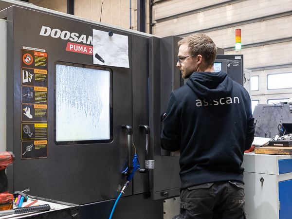 Technicians work with a CNC machine