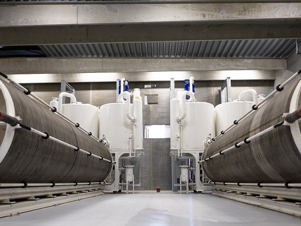 Electrolyzer plant with white tanks in the bagground