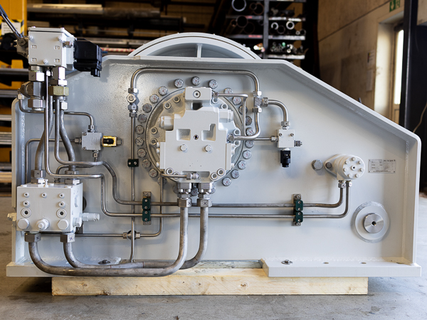 A close-up of the hydraulic motor and gear system, illustrating the complex machinery of winch operation.