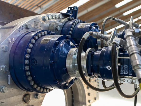 Detailed close-up of blue turner gear, including hydraulic systems and precision bolts.