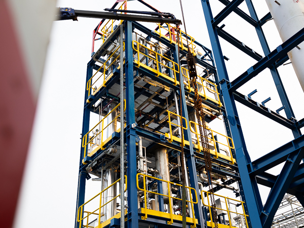 Close-up of a steel structure with yellow safety railings and installation components.