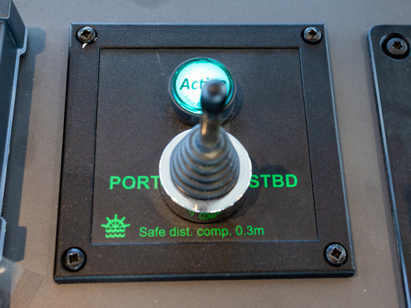 Steering control with joystick and indicator light.