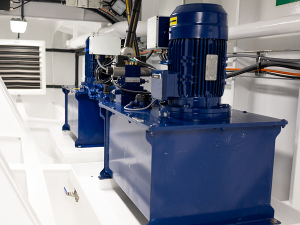 Hydraulic power units (HPU) installed in the steering gear compartment onboard the towing and supply vessel Skawlink. Painted in marine blue for corrosion protection.