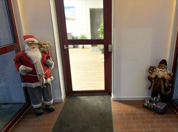 Two Santa figures placed at the AS SCAN entrance creating a festive atmosphere.