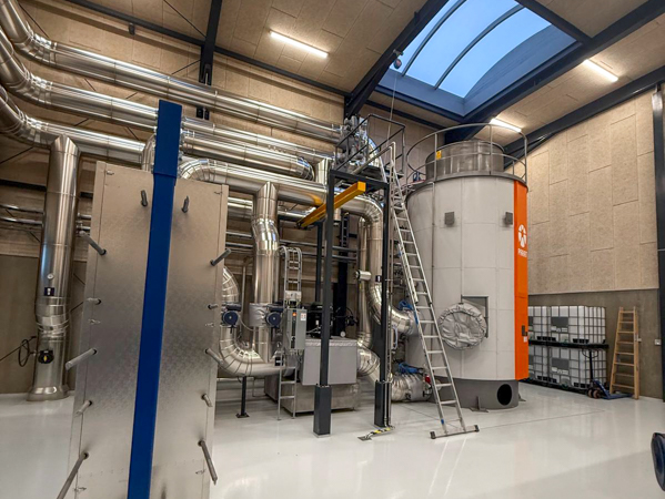 20 MW PARAT electrode boiler integrated into a district heating system with insulated pipes, platform and access arrangements inside the technical building.