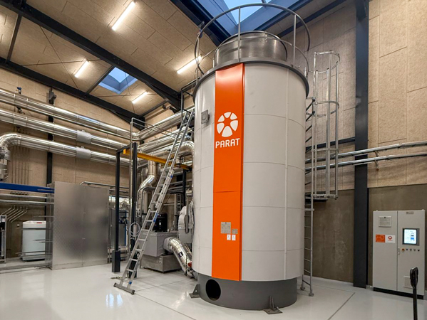 PARAT electrode hot water boiler installed at a Danish district heating plant with visible piping and technical equipment in the boiler room.