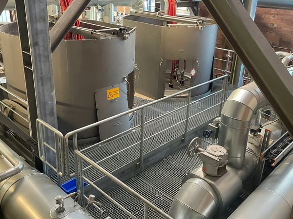 Industrial electrode boilers and associated piping systems at a power plant during service and inspection.