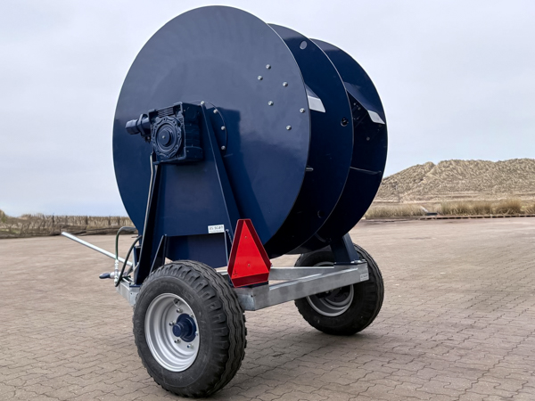 Industrial shore power cable reel mounted on mobile steel frame with gearbox and pneumatic wheels