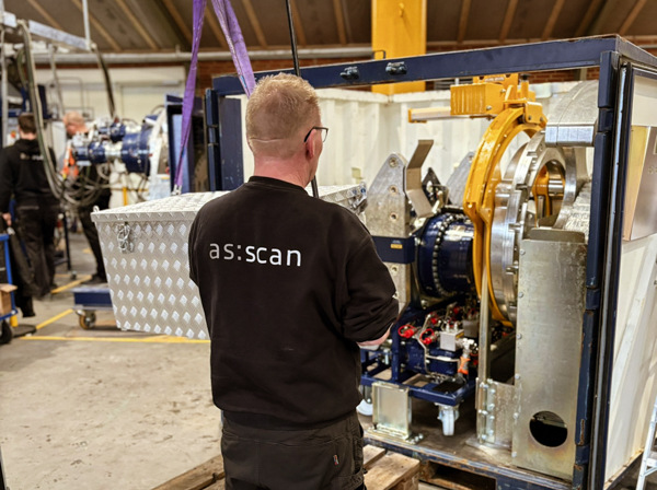 AS SCAN technician inspecting a Turner Gear unit packed in a transport container ready for shipment to a wind turbine installation site.