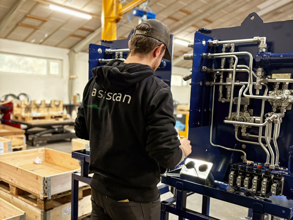 AS SCAN technician mounting a hydraulic panel on a Turner Gear control station during assembly in the workshop.