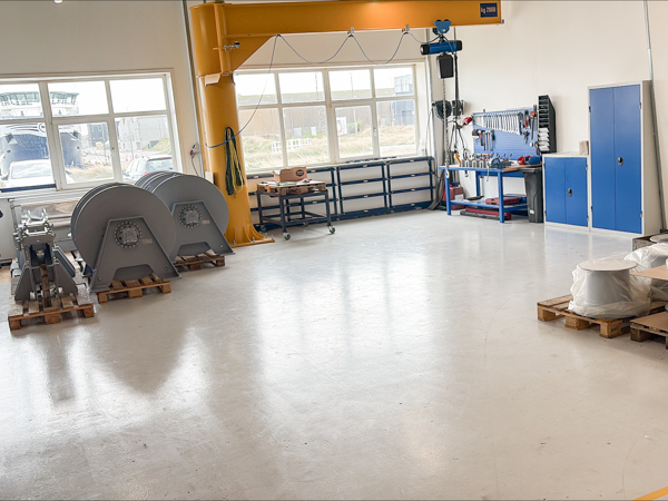 New assembly hall with crane, workstations and staged anchor winches and deck equipment for marine applications