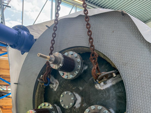 Close-up of the electric boiler’s electrical connections and attached lifting chains.