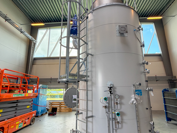 Side view of the electric boiler with access ladder, pipework and instrumentation during installation.